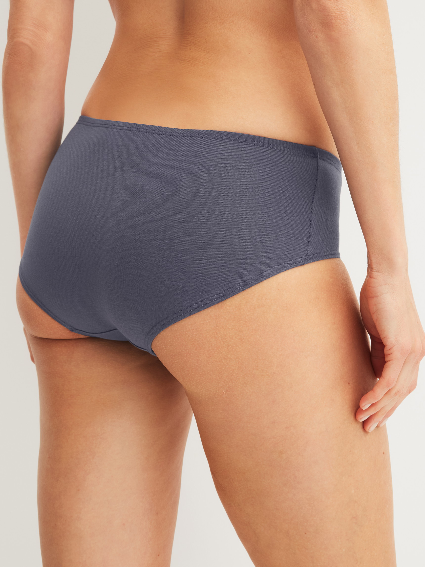 Women model is wearing Low Cut Panty made of Cotton in Grey, Unicoloured from the Essential Cotton series by CALIDA, Back view