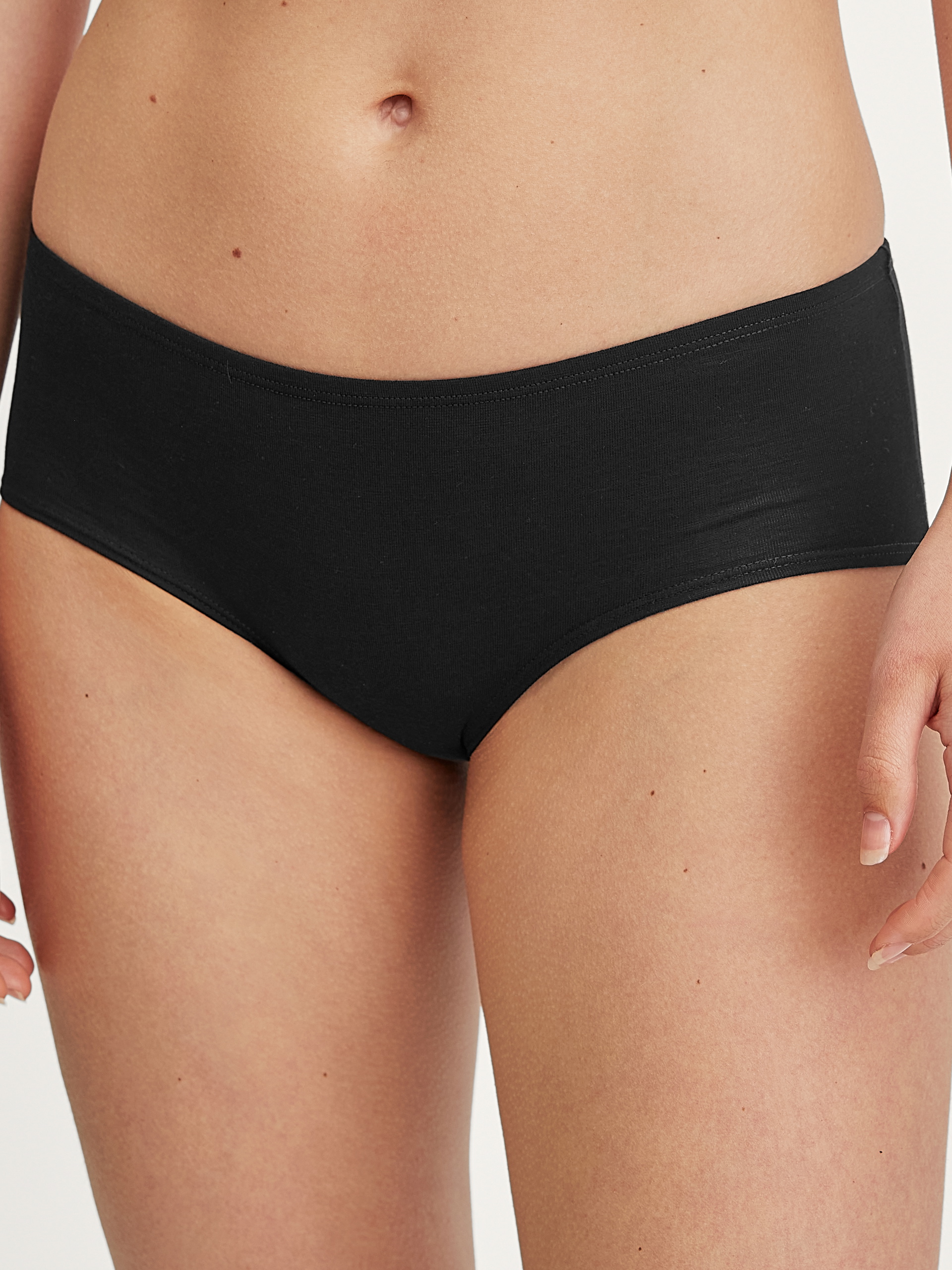 Damen-Model trägt Panty, low cut aus Baumwolle in Schwarz, Einfarbig aus Serie Essential Cotton von CALIDA, Vorderansicht