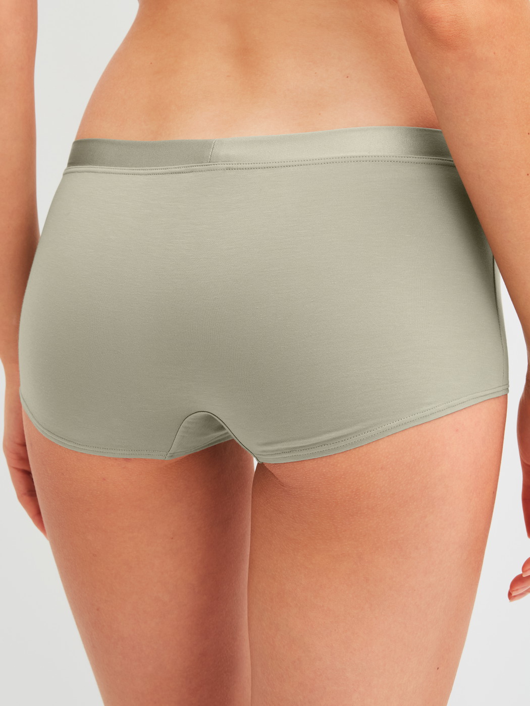 Women model is wearing Shorty regular cut made of Cotton in Green, Unicoloured from the Cate series by CALIDA, Back view