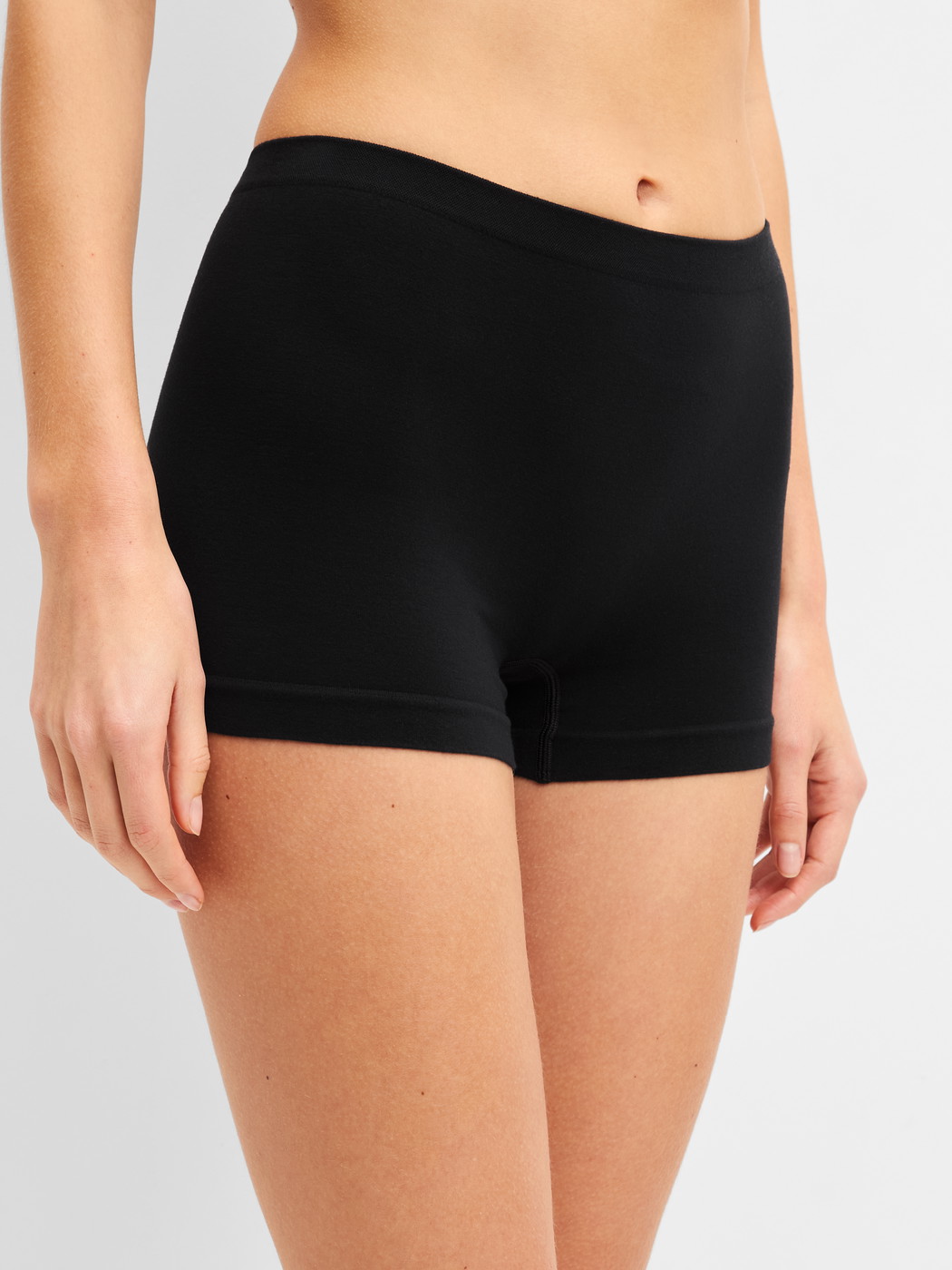 Women model is wearing Shorty regular cut made of Modal in Black, Unicoloured from the Seamless Natural series by CALIDA, Front view