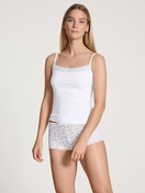 Women model is wearing Shorty regular cut made of Swiss+Cotton in White, Lace from the Natural Comfort Lace series by CALIDA, Front view, Outfit