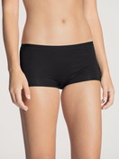 Women model is wearing Shorty regular cut made of Cotton in Black, Unicoloured from the Natural Comfort series by CALIDA, Front view