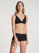 Women model is wearing Shorty regular cut made of Cotton in Black, Unicoloured from the Natural Comfort series by CALIDA, Outfit