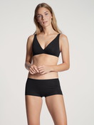 Women model is wearing Shorty regular cut made of Cotton in Black, Unicoloured from the Natural Comfort series by CALIDA, Outfit