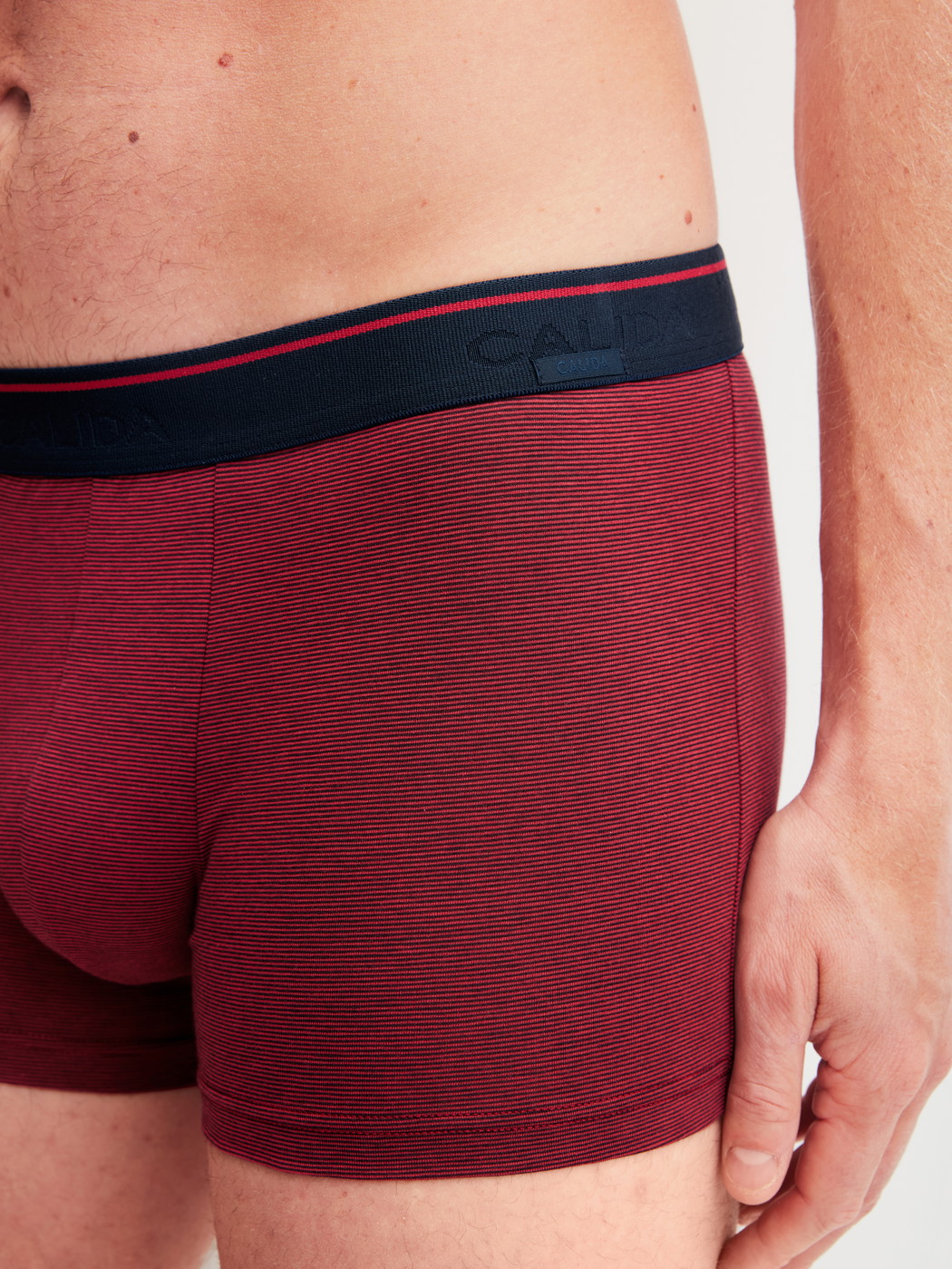 Men model is wearing Boxer brief made of Cotton in Red, Unicoloured from the Cotton Stretch series by CALIDA, Detail