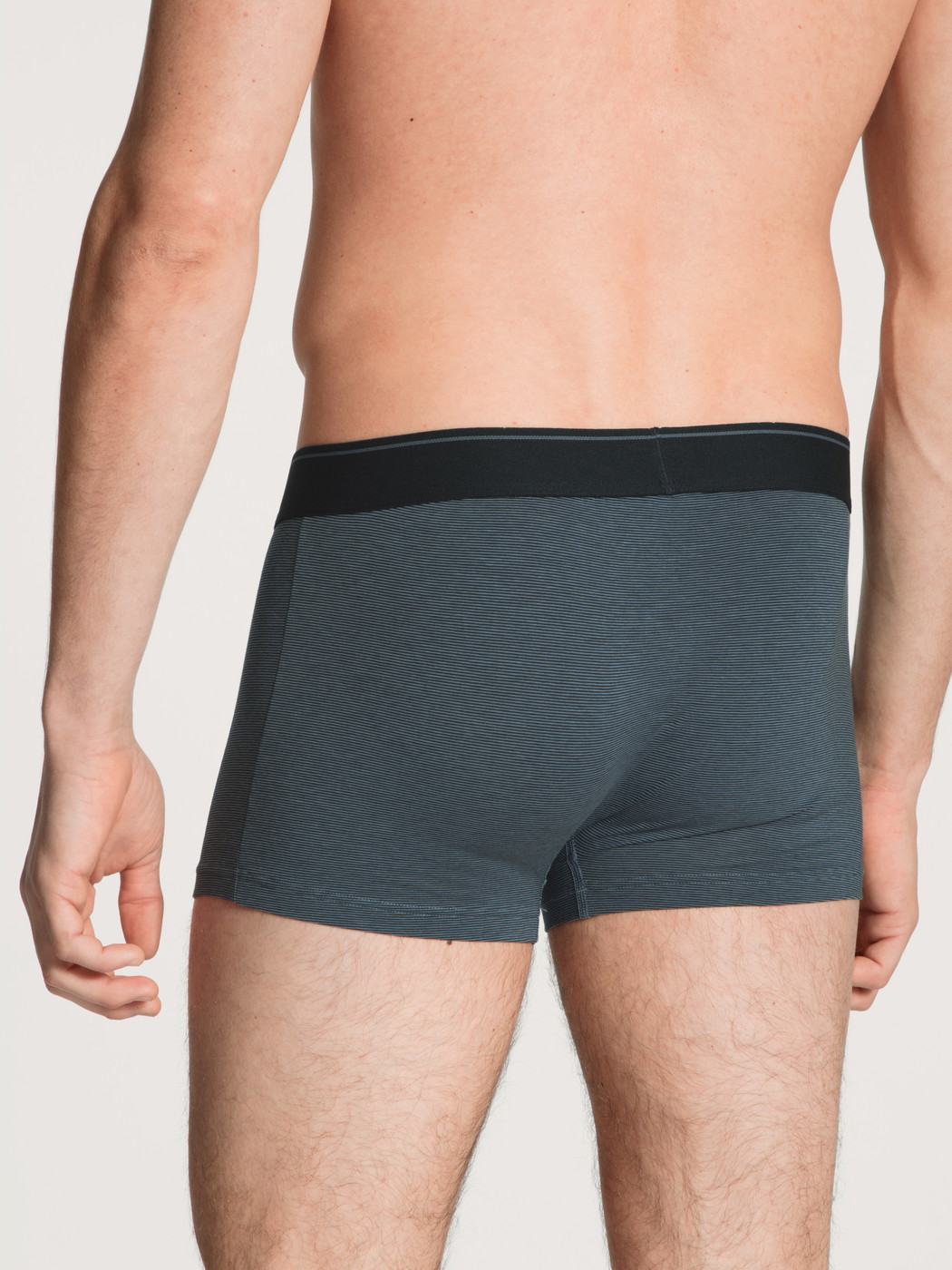Men model is wearing Boxer brief made of Cotton in Blue, Unicoloured from the Cotton Stretch series by CALIDA, Back view