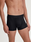 Men model is wearing Extended Boxer Briefs made of TENCEL™ in Black, Unicoloured from the Natural Cooling series by CALIDA, Front view