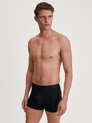 Men model is wearing Extended Boxer Briefs made of TENCEL™ in Black, Unicoloured from the Natural Cooling series by CALIDA, Outfit