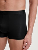 Men model is wearing Extended Boxer Briefs made of TENCEL™ in Black, Unicoloured from the Natural Cooling series by CALIDA, Detail