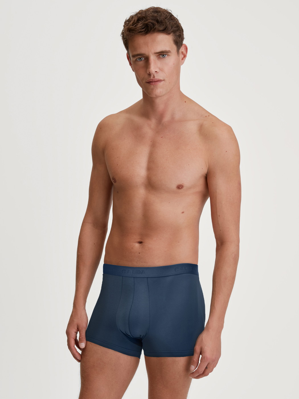 Men model is wearing Boxer brief made of Cotton in Blue, Unicoloured from the Evolution series by CALIDA, Outfit