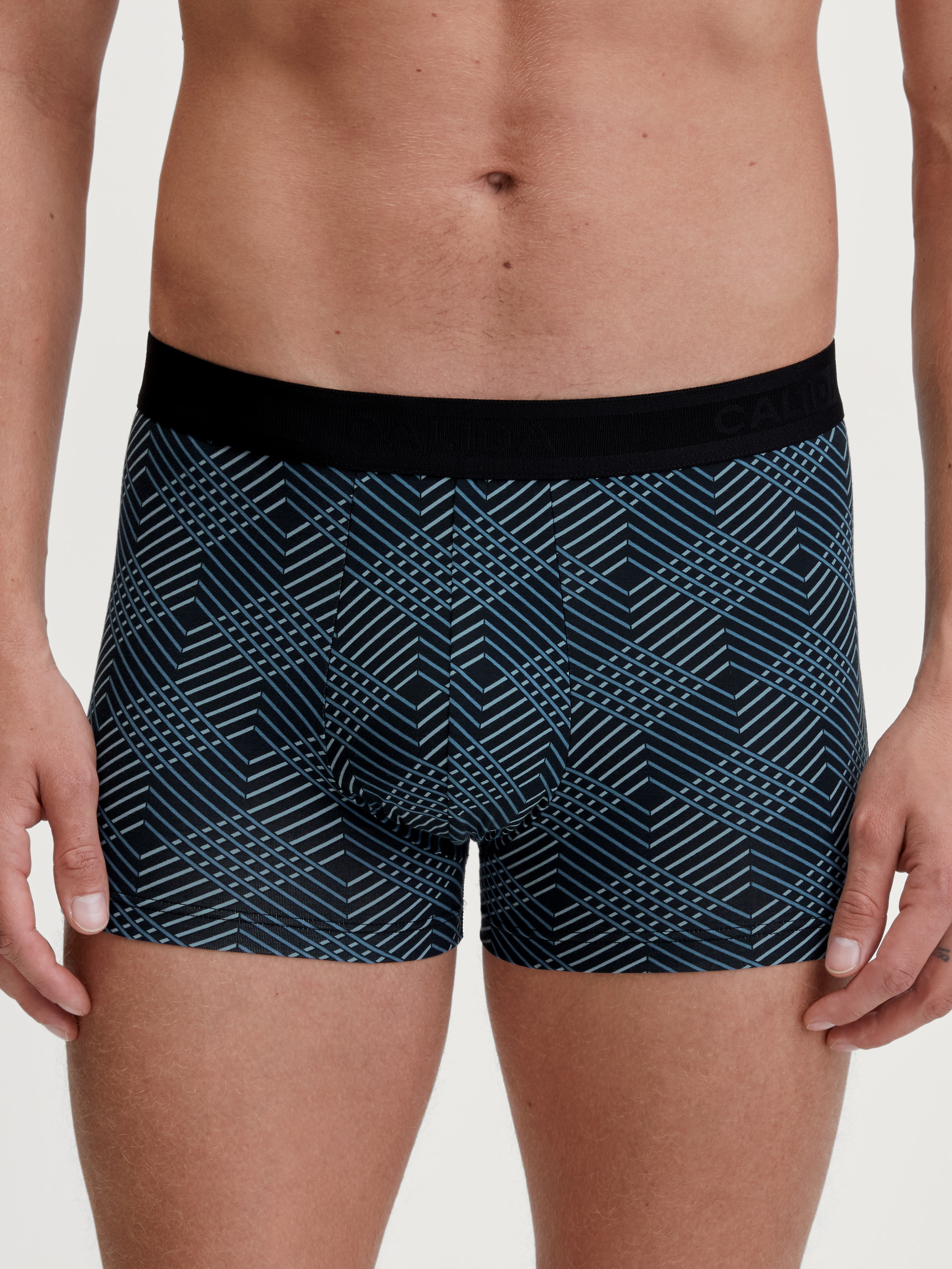 Men model is wearing Boxer brief made of Cotton in Black, Patterned from the Grafic Cotton series by CALIDA, Front view