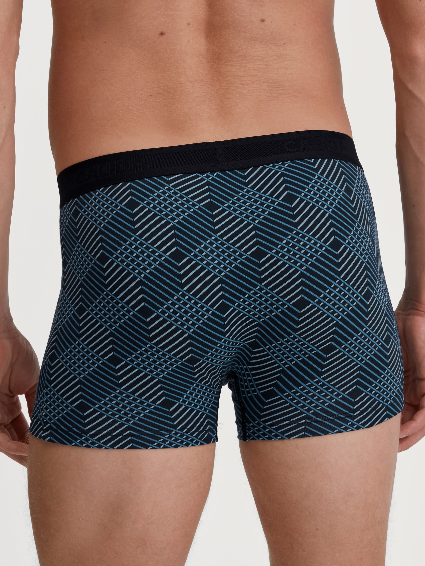 Men model is wearing Boxer brief made of Cotton in Black, Patterned from the Grafic Cotton series by CALIDA, Back view