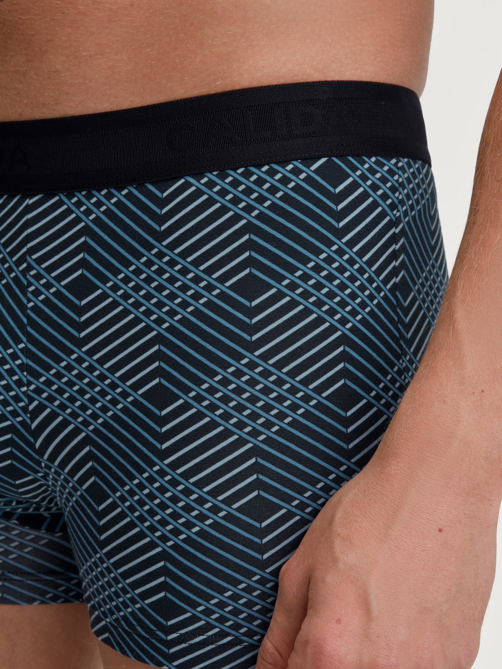Men model is wearing Boxer brief made of Cotton in Black, Patterned from the Grafic Cotton series by CALIDA, Detail