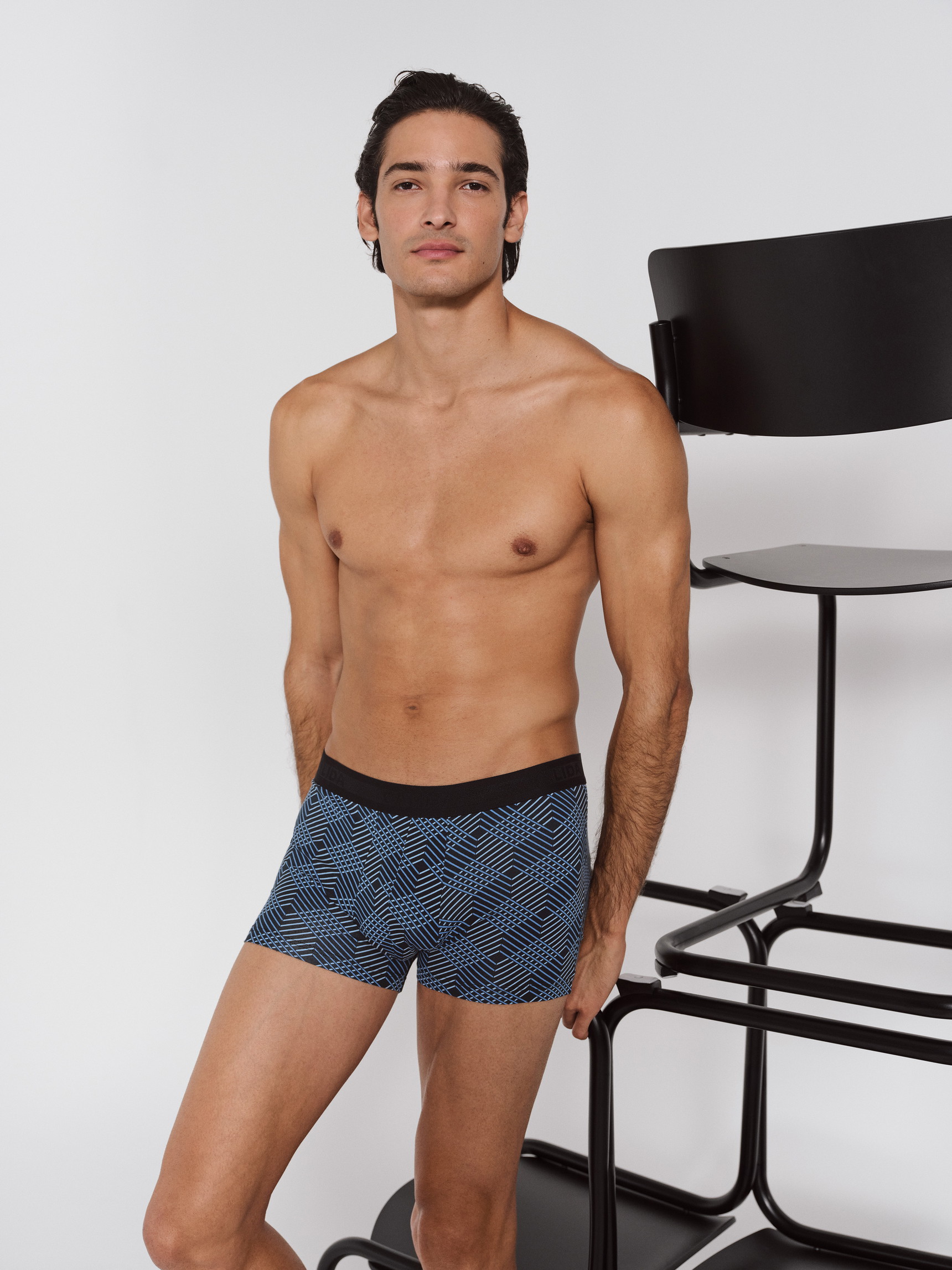 Men model is wearing Boxer brief made of Cotton in Black, Patterned from the Grafic Cotton series by CALIDA, Additional Image
