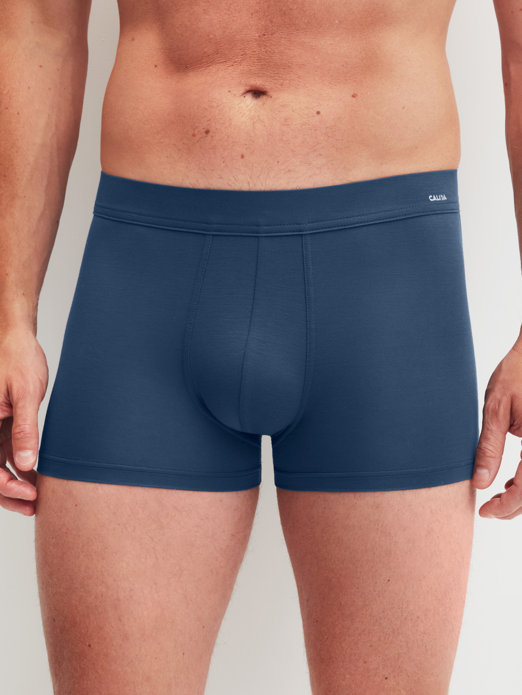 Men model is wearing Boxer brief with Quick Dry Effect made of Modal in Blue, Unicoloured from the Balanced Day series by CALIDA, Front view