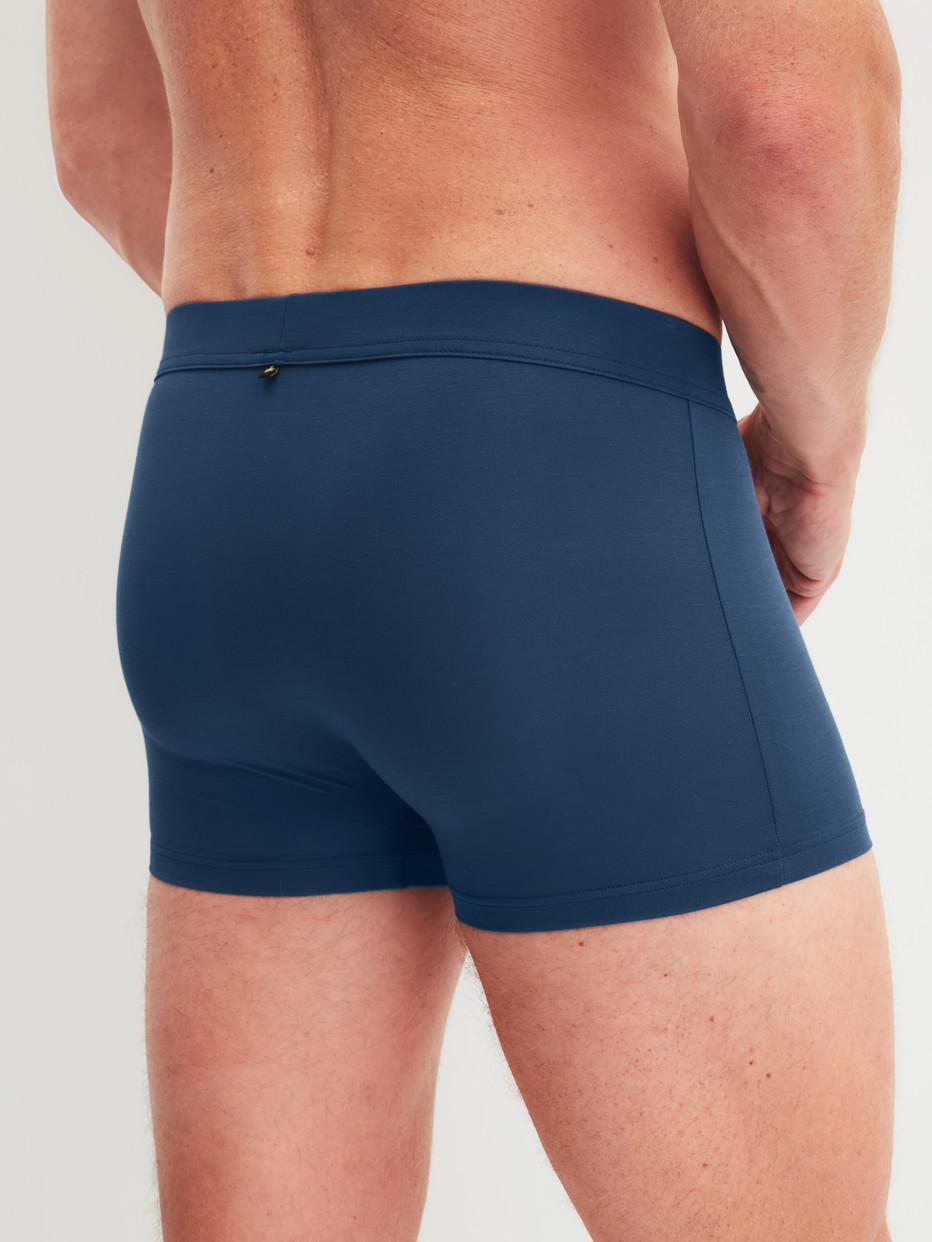 Men model is wearing Boxer brief with Quick Dry Effect made of Modal in Blue, Unicoloured from the Balanced Day series by CALIDA, Back view