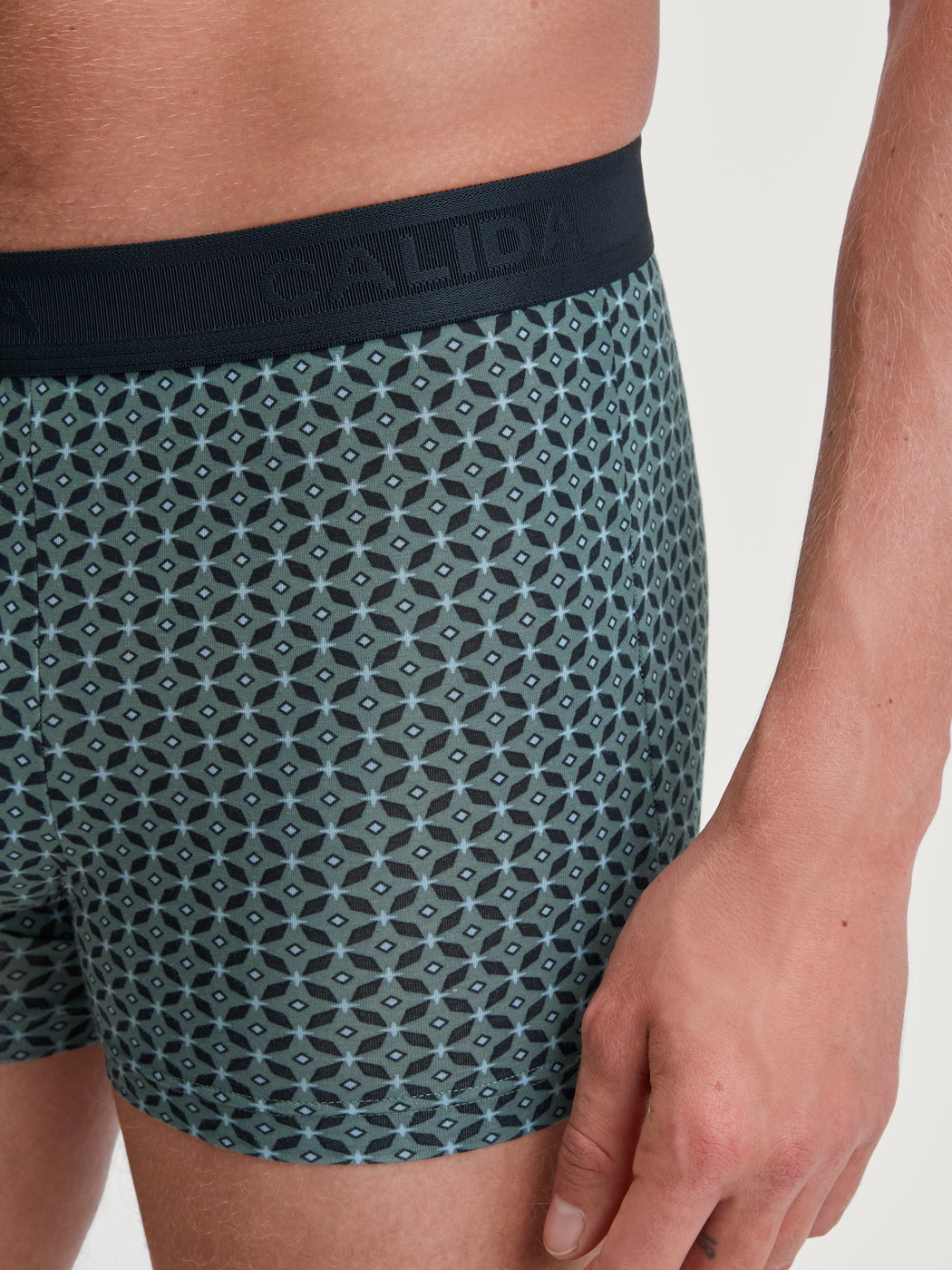 Men model is wearing Boxer brief made of TENCEL™ in Green, Patterned from the Focus Trend series by CALIDA, Detail