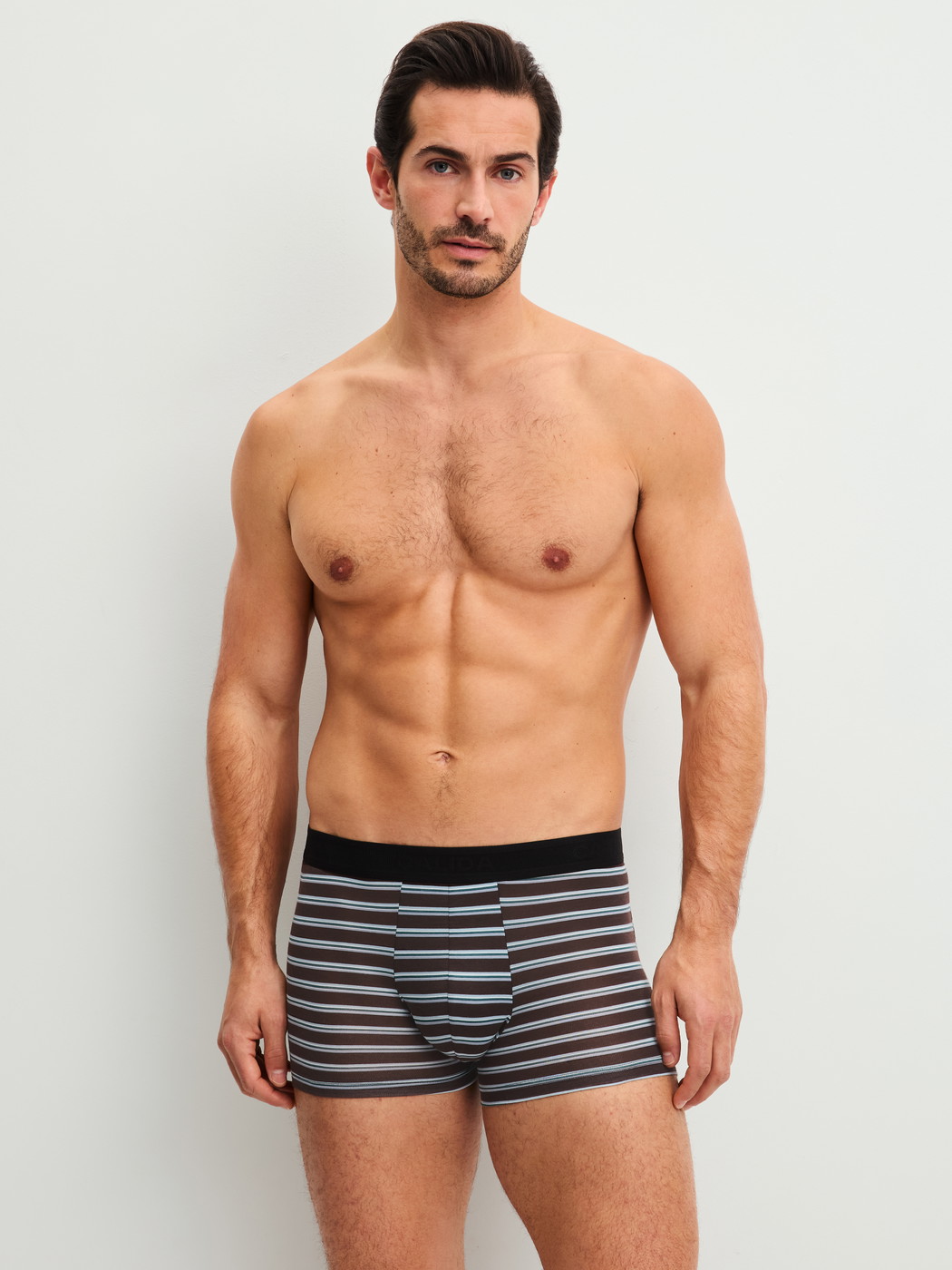 Men model is wearing Boxer brief made of Lyocell in Brown, Striped from the Focus Trend series by CALIDA, Outfit