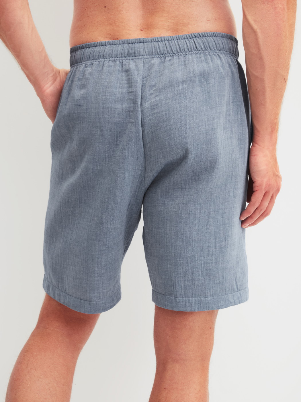 Men model is wearing Bermudas with side pockets made of 100% Cotton in Grey, Unicoloured from the RMX Sleep Journey series by CALIDA, Back view