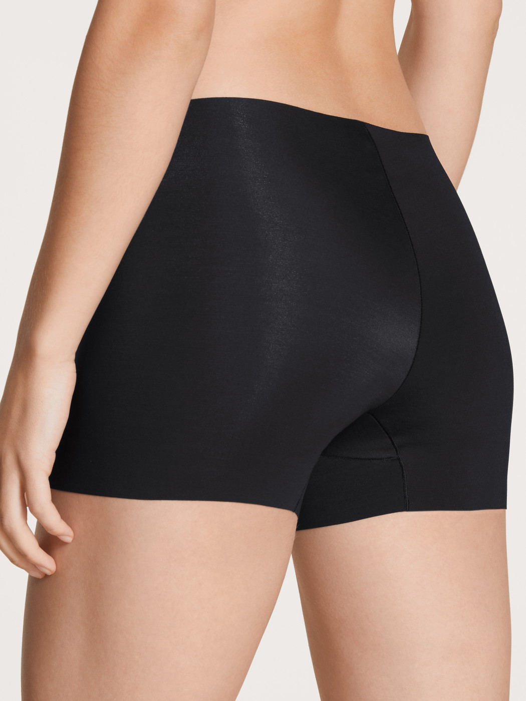 Women model is wearing Pants made of Modal in Black, Unicoloured from the Natural Skin series by CALIDA, Back view