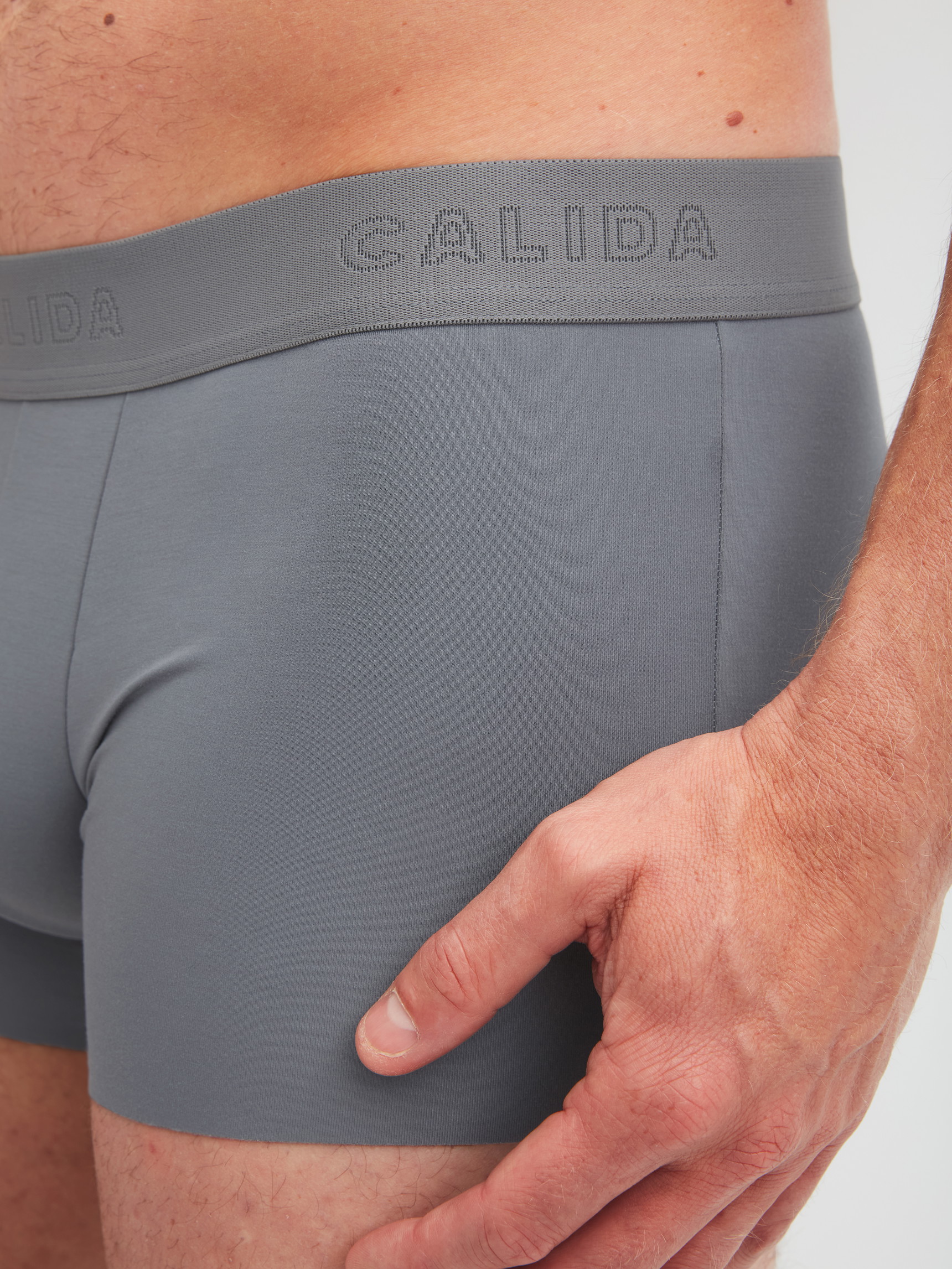 Men model is wearing Boxer brief with elastic waistband made of Modal in Grey, Unicoloured from the Clean Line series by CALIDA, Detail
