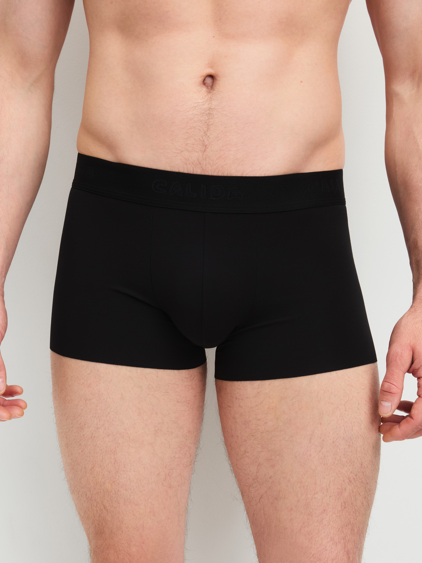 Men model is wearing Boxer brief with elastic waistband made of Modal in Black, Unicoloured from the Clean Line series by CALIDA, Front view