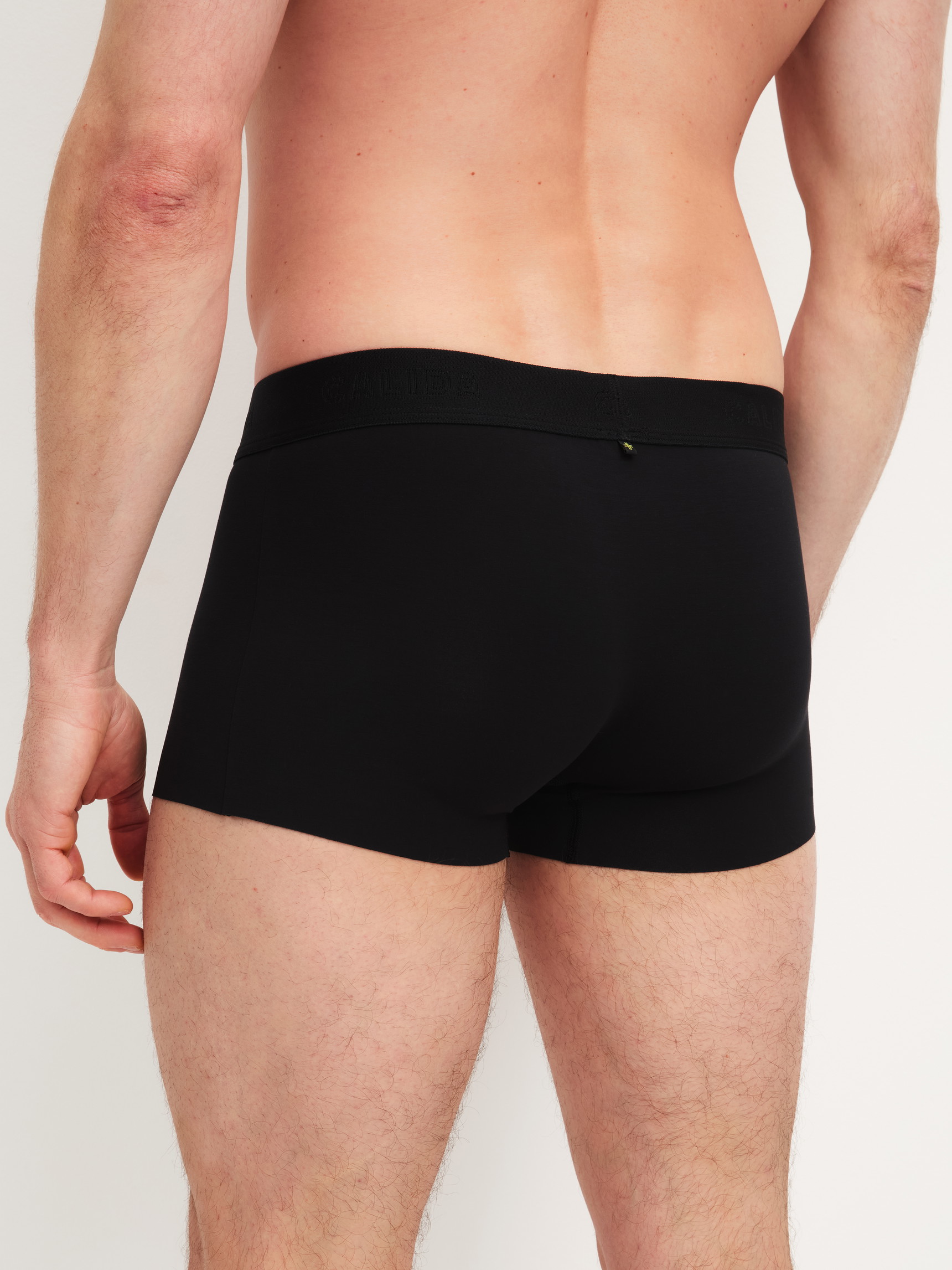 Men model is wearing Boxer brief with elastic waistband made of Modal in Black, Unicoloured from the Clean Line series by CALIDA, Back view