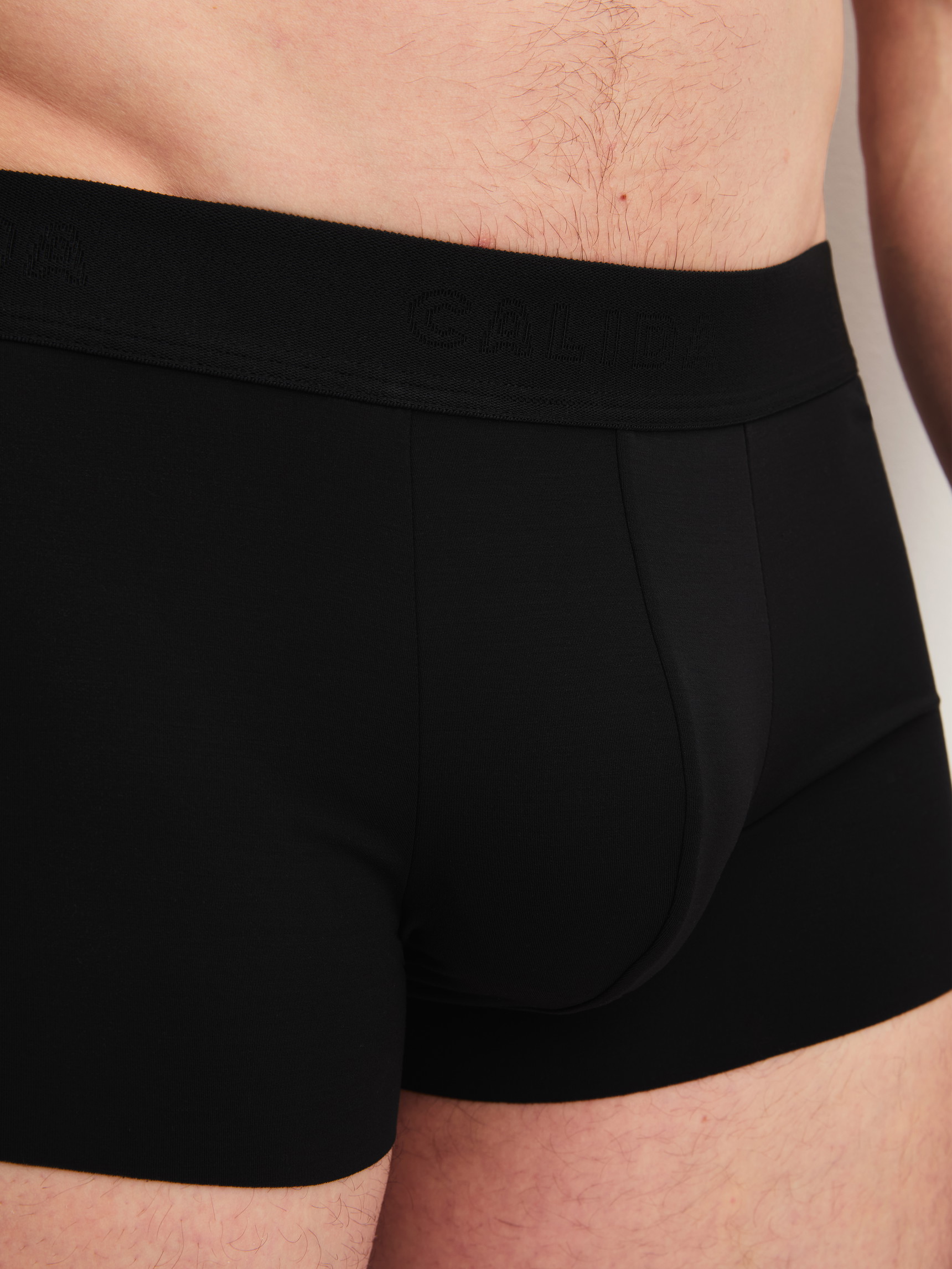 Men model is wearing Boxer brief with elastic waistband made of Modal in Black, Unicoloured from the Clean Line series by CALIDA, Detail