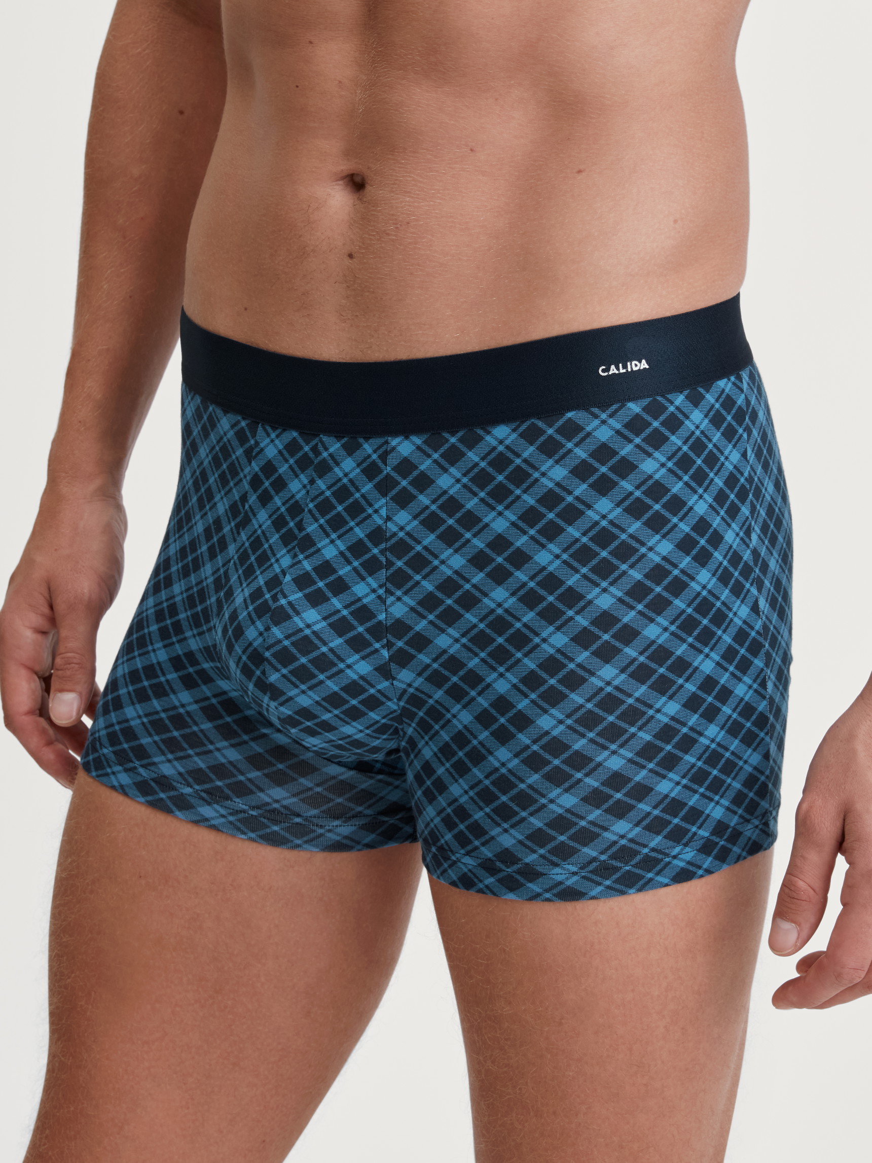 La modella / Il modello Uomo indossa Boxer brief in Cotone di colore Blu, A scacchi, della serie Cotton Code Design di CALIDA, Vista frontale