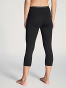 Women model is wearing 3/4 Leggings made of Cotton in Black, Unicoloured from the Natural Comfort series by CALIDA, Back view