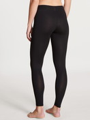 Women model is wearing Leggings made of Cotton in Black, Unicoloured from the Elastic series by CALIDA, Back view