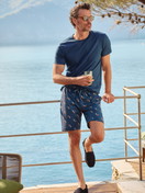 Herren-Model trägt Bermudas aus 100% Baumwolle in Blau, Gemustert aus Serie RMX Sleep Holiday von CALIDA, Zusatzbild