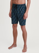 Men model is wearing Bermudas made of 100% Cotton in Black, Patterned from the RMX Sleep Leisure series by CALIDA, Front view