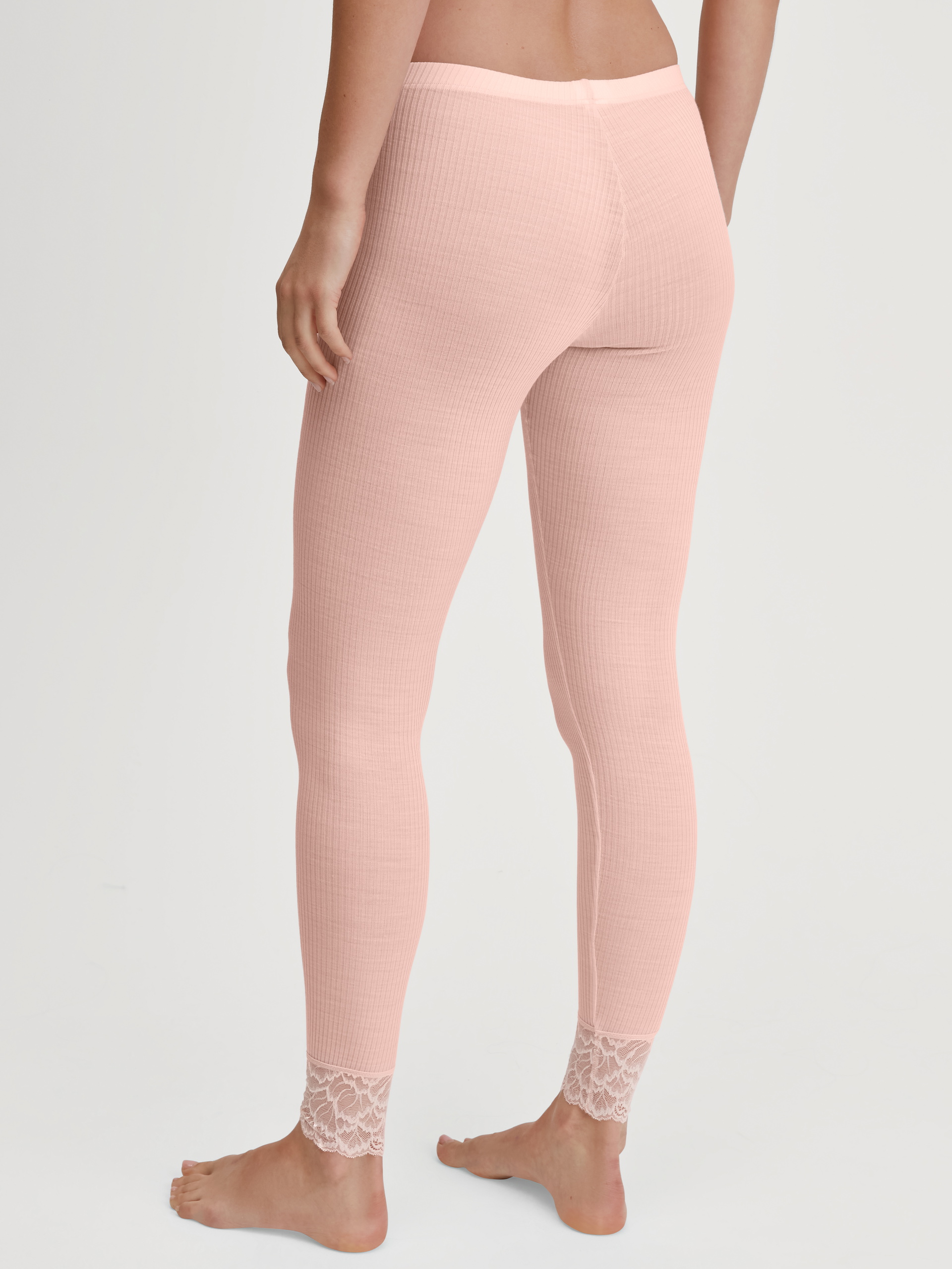 Women model is wearing Leggings in Wool and Silk made of Wool in Pink, Lace from the Silky Wool Joy series by CALIDA, Back view