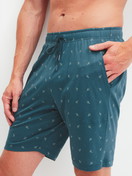 Men model is wearing Bermudas with side pockets made of Cotton in Turquoise, Patterned from the RMX Sleep Free series by CALIDA, Front view