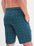 Men model is wearing Bermudas with side pockets made of Cotton in Turquoise, Patterned from the RMX Sleep Free series by CALIDA, Back view