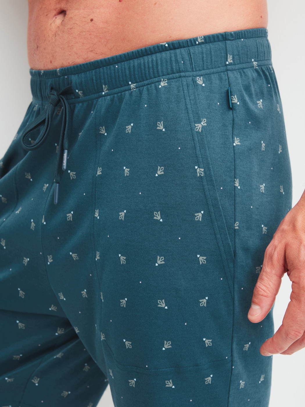 Men model is wearing Bermudas with side pockets made of Cotton in Turquoise, Patterned from the RMX Sleep Free series by CALIDA, Detail