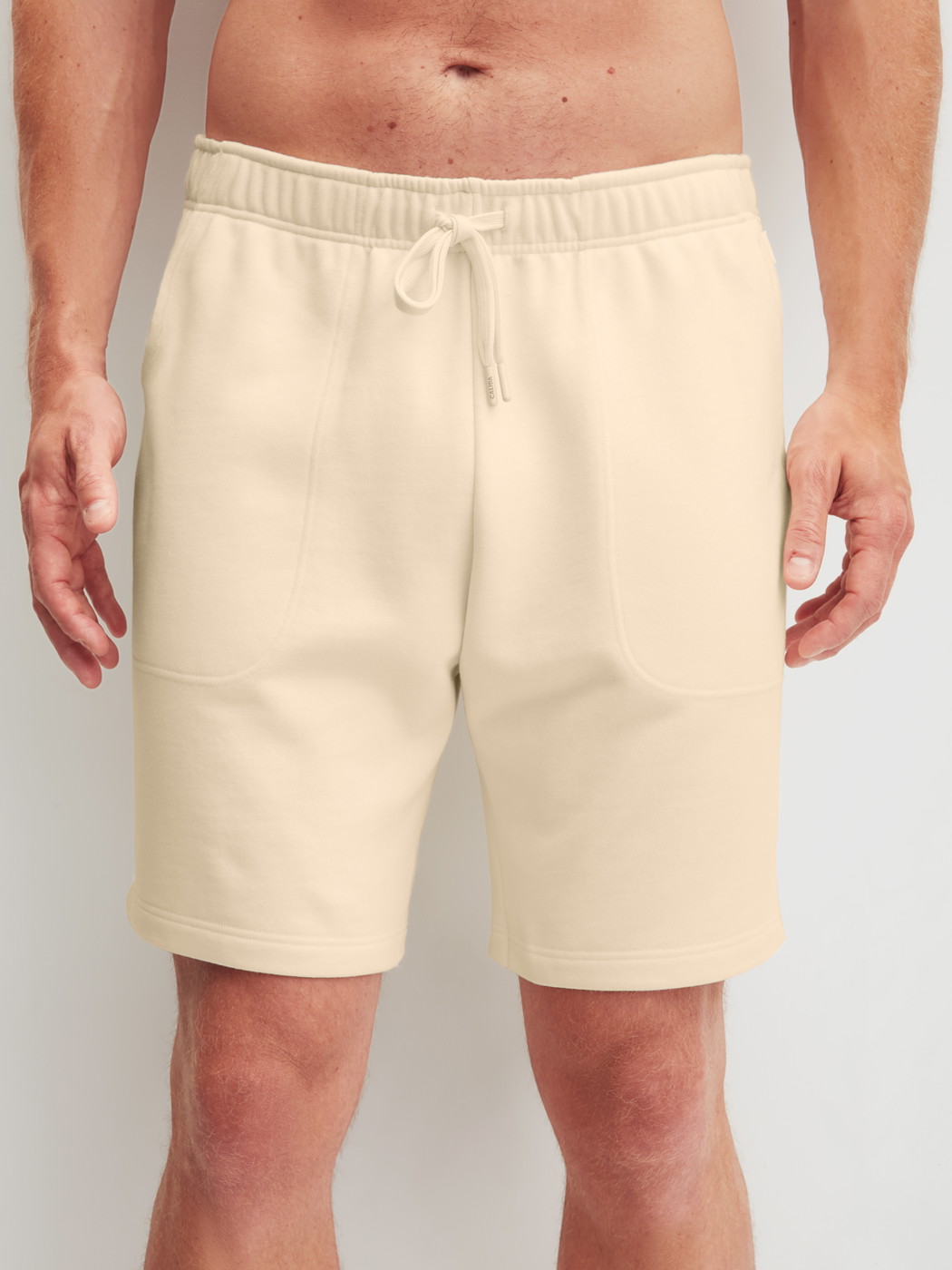 Men model is wearing Bermudas with side pockets made of Cotton in Beige, Unicoloured from the RMX Lounge Lecce series by CALIDA, Front view