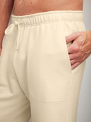 Men model is wearing Bermudas with side pockets made of Cotton in Beige, Unicoloured from the RMX Lounge Lecce series by CALIDA, Detail