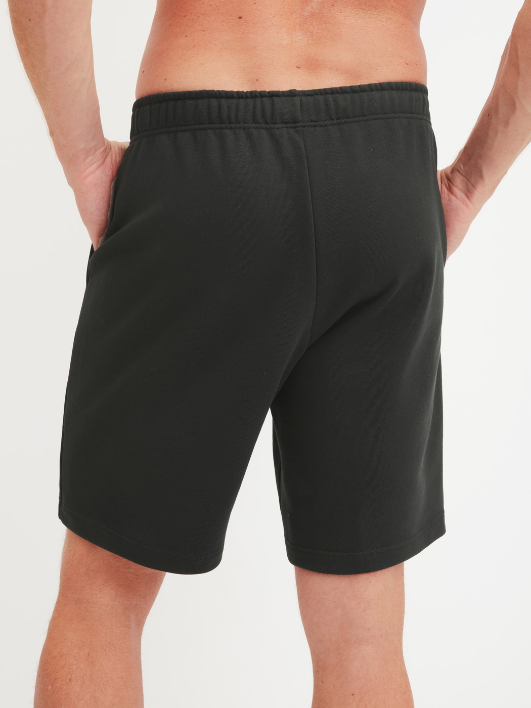 Men model is wearing Bermudas with side pockets made of Cotton in Black, Unicoloured from the RMX Lounge Lecce series by CALIDA, Back view