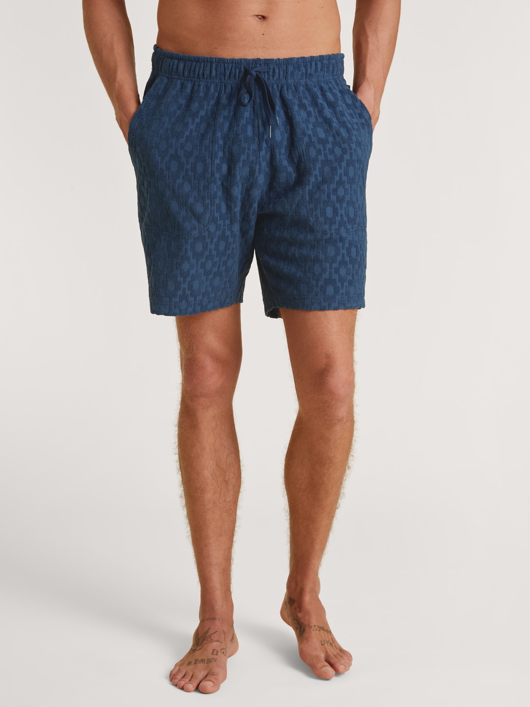 Men model is wearing Bermudas made of Cotton in Blue, Unicoloured from the RMX Lounge Holiday series by CALIDA, Front view