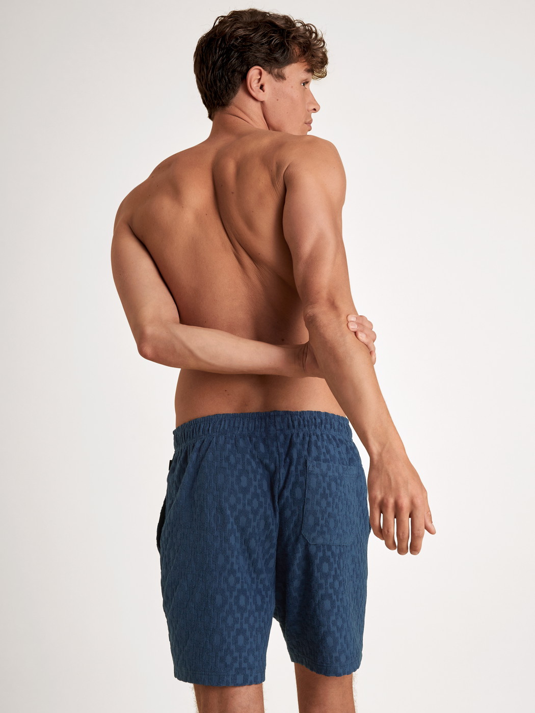 Men model is wearing Bermudas made of Cotton in Blue, Unicoloured from the RMX Lounge Holiday series by CALIDA