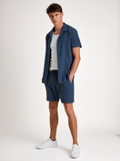 Men model is wearing Bermudas made of Cotton in Blue, Unicoloured from the RMX Lounge Holiday series by CALIDA