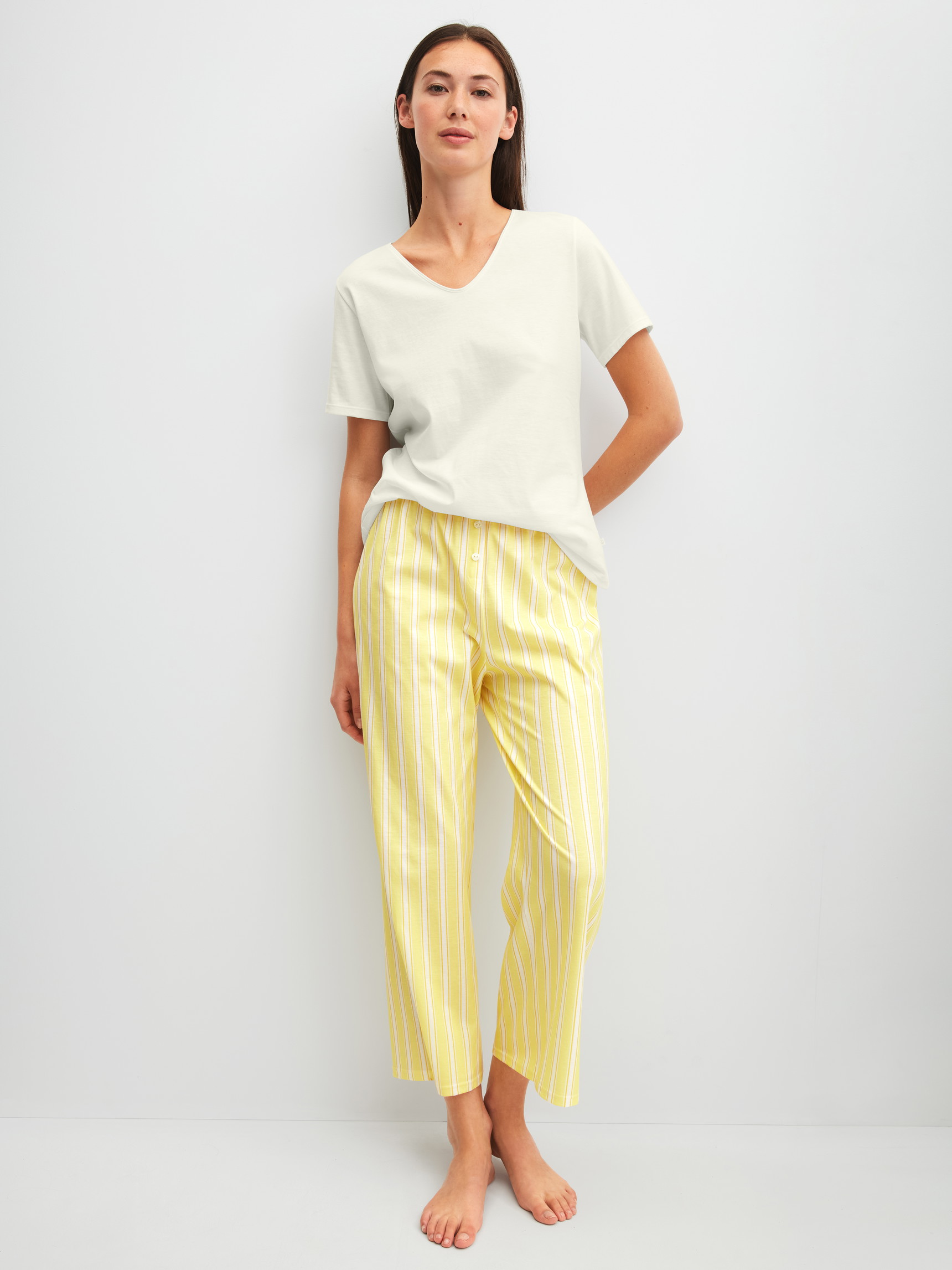 Women model is wearing 7/8 pyjama trousers made of 100% Cotton in Yellow, Striped from the Favourites Ocean series by CALIDA, Outfit