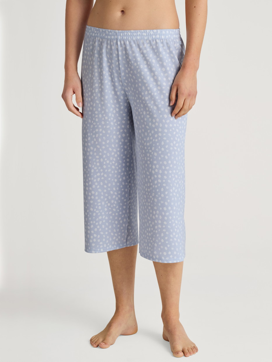 Women model is wearing 3/4 Pyjama bottom made of 100% Cotton in Blue, Patterned from the Favourites Sleep series by CALIDA, Front view