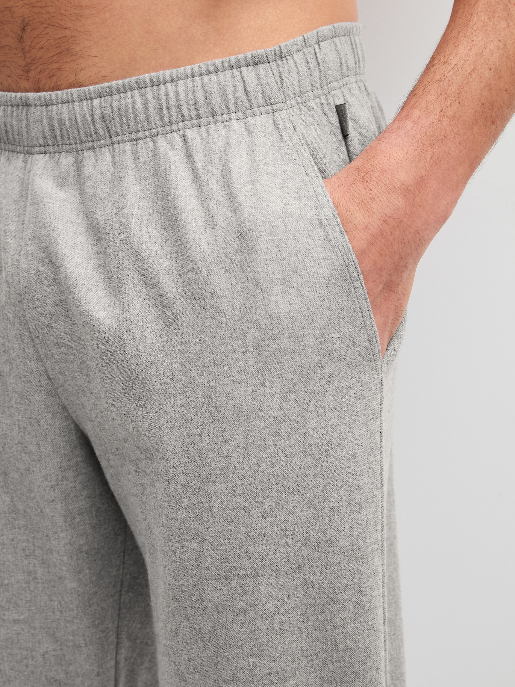 Men model is wearing Flannel trousers with side pockets made of Flanell in Grey, Patterned from the RMX Flannel Mood series by CALIDA, Detail