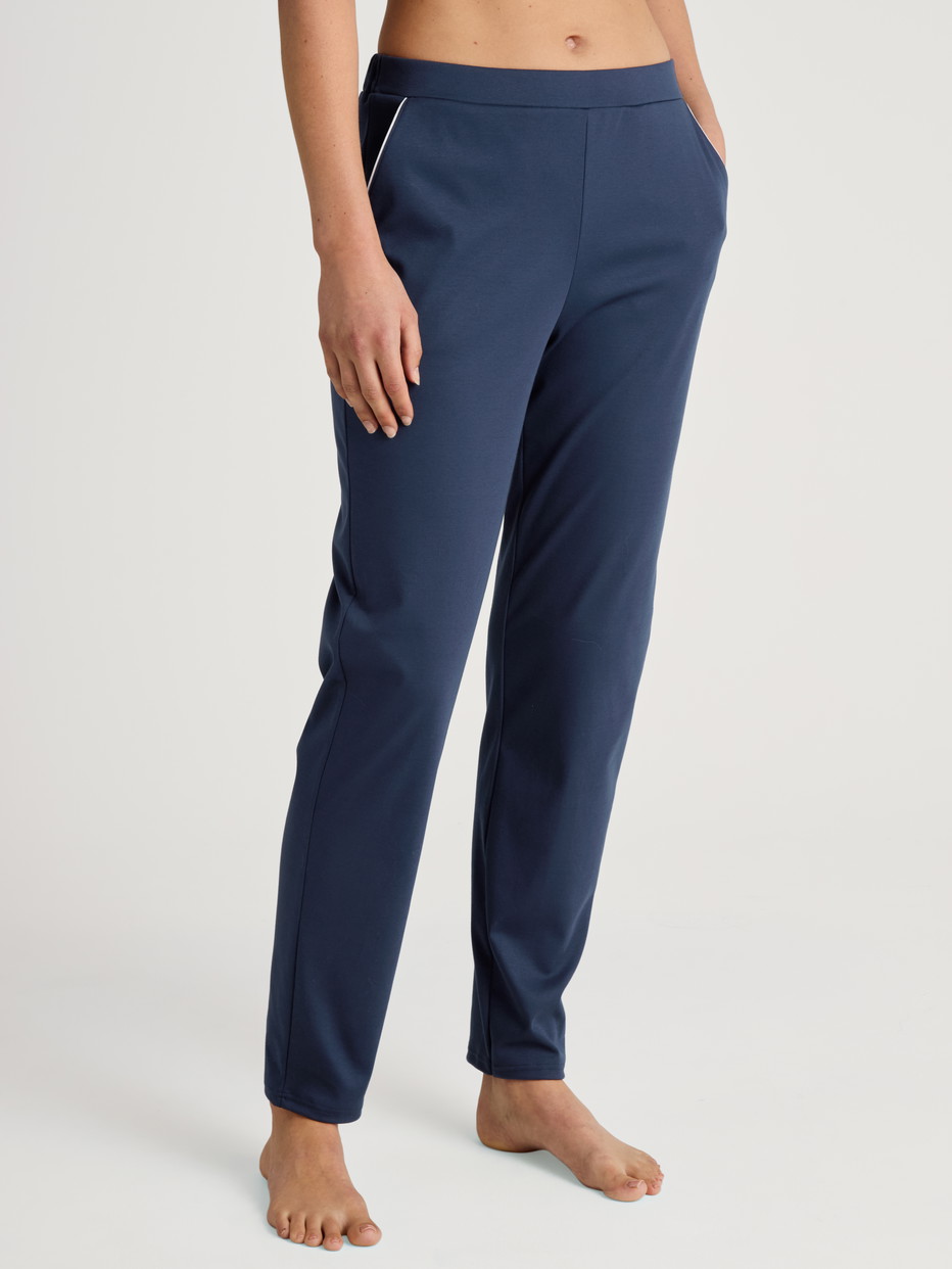 Women model is wearing Pyjama bottom made of 100% Cotton in Blue, Unicoloured from the Favourites Sleep series by CALIDA, Front view