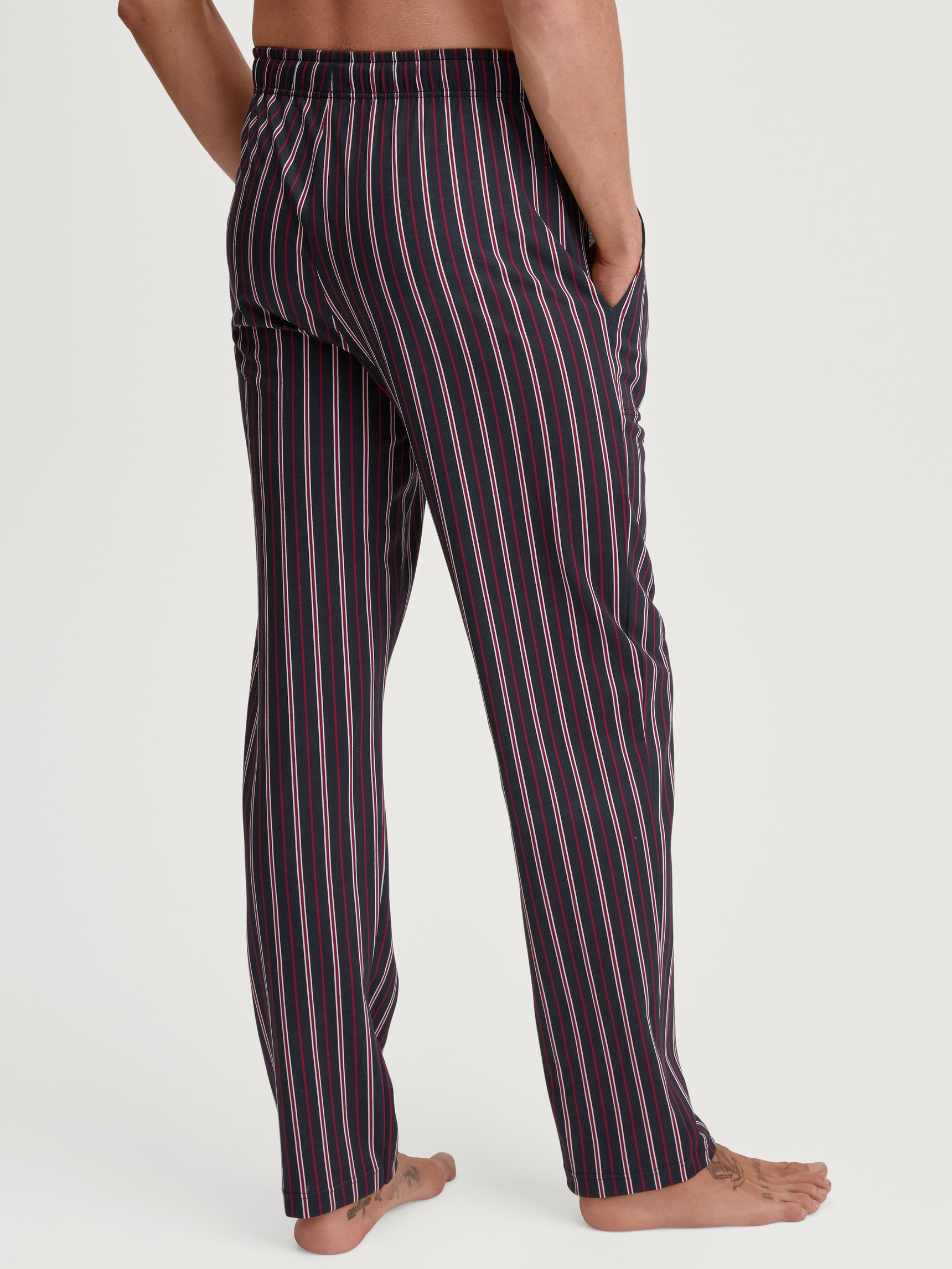 Men model is wearing Pyjama Bottoms with Side Pockets made of 100% Cotton in Red, Checked from the Remix Basic Sleep series by CALIDA, Back view