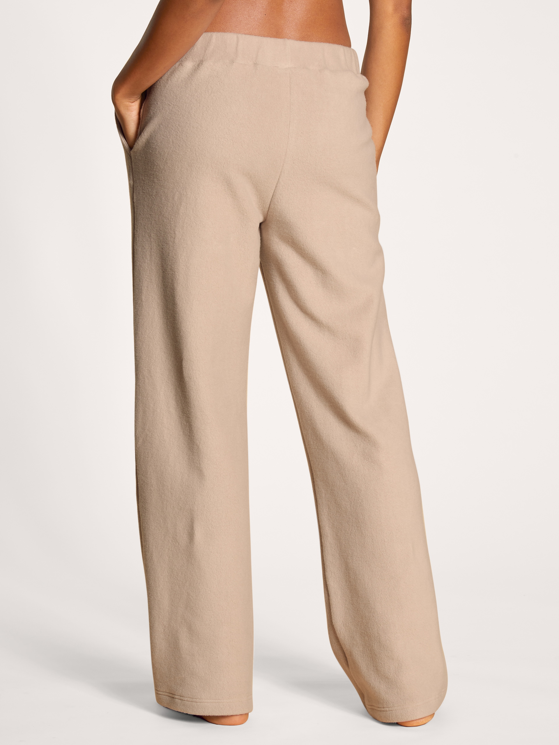 Women model is wearing Pants made of Viscose in Beige, Unicoloured from the The Home Hub series by CALIDA, Back view