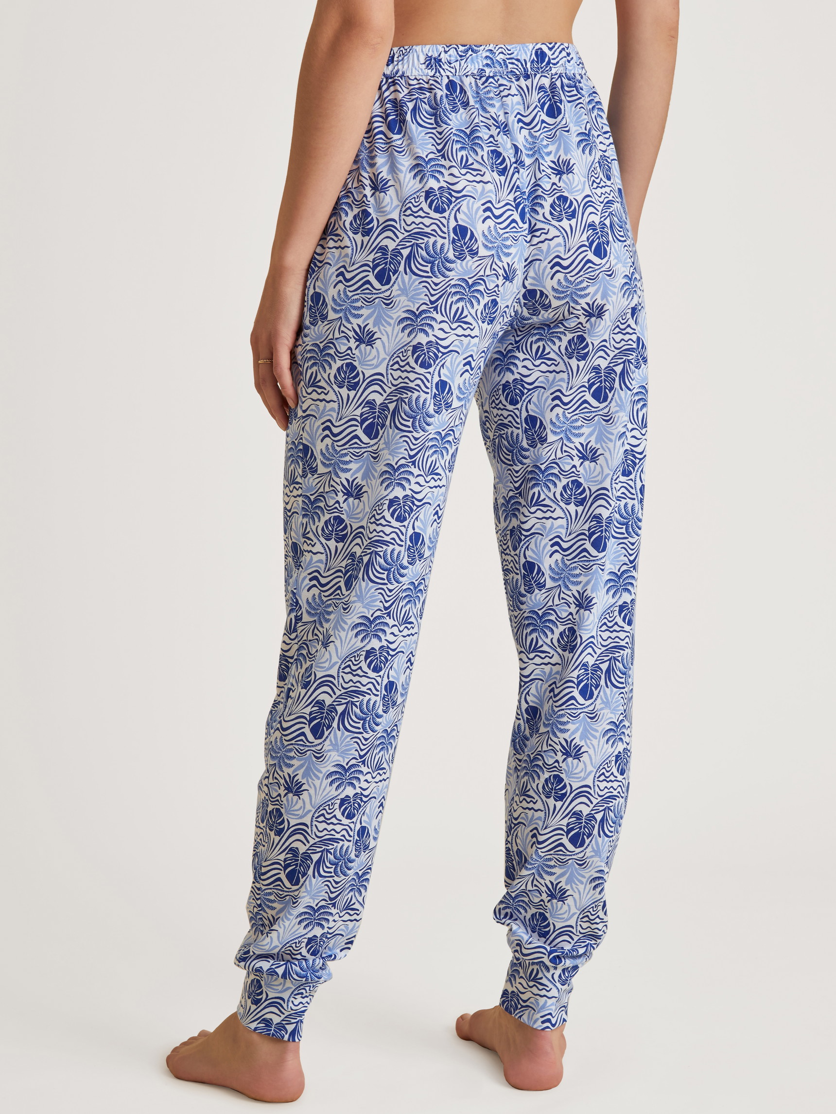 Women model is wearing Pants made of Modal in Blue, Floral from the Favourites Serenity series by CALIDA, Back view